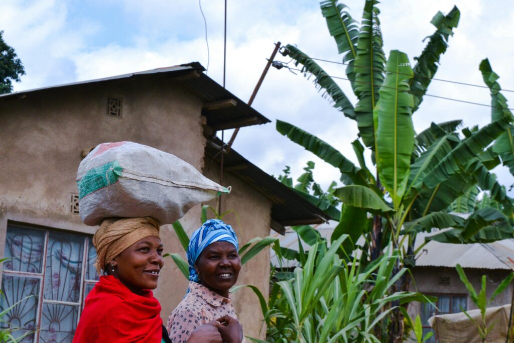 Two Tanzanian women standing at the backyard of the house
